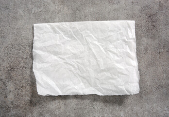 White paper napkin on grey stone table top view,food advertisement element,empty space blank.Baking paper.