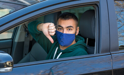 health protection, safety and pandemic concept,taxi driver showing thumbs down sign