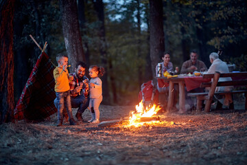 Wall Mural - People with children on picnic in wood