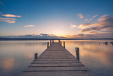 Fototapeta Sypialnia - Old wooden dock at the lake, sunset shot