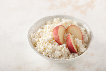 Wall Mural - Healthy breakfast or dessert - cottage cheese with peaches and berries in a bowl on the table