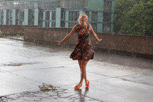 Attractive Caucasian Female Dancing Under The Summer Rain