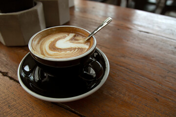 Hot coffee cup on the wooden table