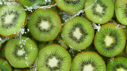 Wall Mural - Top view of sliced kiwi with water splashes