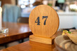 A wooden sign with number 47 marking the visitors queue number waiting for food as part of new normal at restaurants after Covid-19