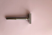 Reusable Metal Safety Razor On Pink Background. Top View.