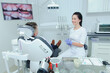 © lisovoy - A child boy with a dentist in a dental office