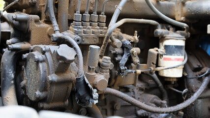 Wall Mural - Hydraulic oil tank on an old engine. Heavy equipment gets dirty through heavy use with dusty engines and lack of maintenance. Choose subject and focus closer.