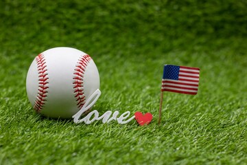 Wall Mural - Baseball is on green grass with love word 