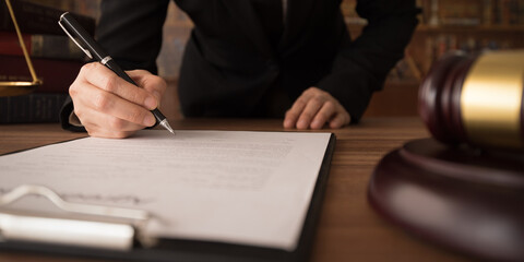 lawyer businessman signning legal document at law office for consultant legislation.