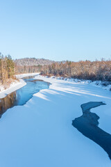 Wall Mural - Frozen Snow Covered River in Winter in Latvia