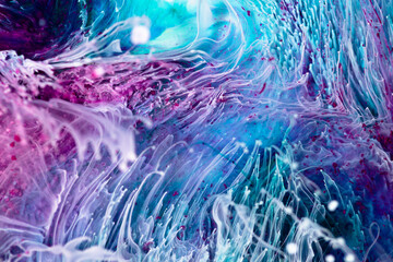 Resin art paint with blue, purple and white colors. Liquid background with splashes and ripples. Modern abstract texture with alcohol inks. Vibrant colors mixes on macrophotography wallpaper