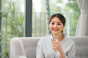 Poster - Beautiful young woman drinking water at home