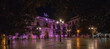 panorama of the purple lit townhouse of granada, ajuntamiento, on the Plaza del Carmen at night in the old town of granada, spain