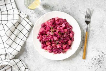 Wall Mural - Traditional Scandinavian beetroot and apple salad with mayonnaise, sour cream and balsamic vinegar. Pickled beets with apples in a white plate on a light gray table. Top view