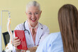 © Bangkok Click Studio - Senior older female doctor taking, explaining and history taking with a patient with a smiley face and intimate manner