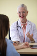 © Bangkok Click Studio - Senior older female doctor taking, explaining and history taking with a patient with a smiley face and intimate manner