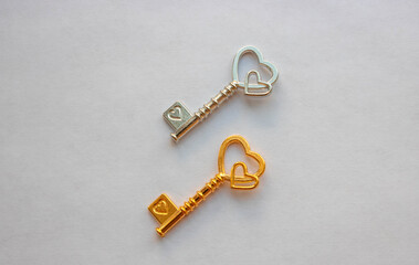 Gold and silver keys, with hearts isolated on a white background