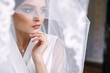 © Ivan - charming bride wrapped in a veil. Wedding morning.