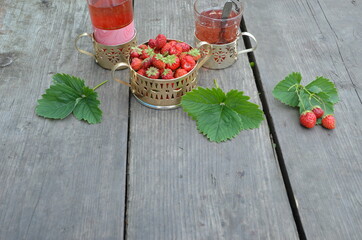 Berry strawberry tea and fresh garden strawberries on wooden background