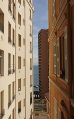 The sea in perspective in the middle of two buildings 