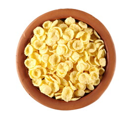 Crunchy corn flakes, cereal, muesli pile in clay pot isolated on white background, top view