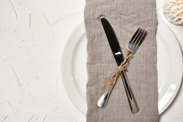 food concept stylish table setting cutlery on white table with silver fork and knife. top view or flat lay                         