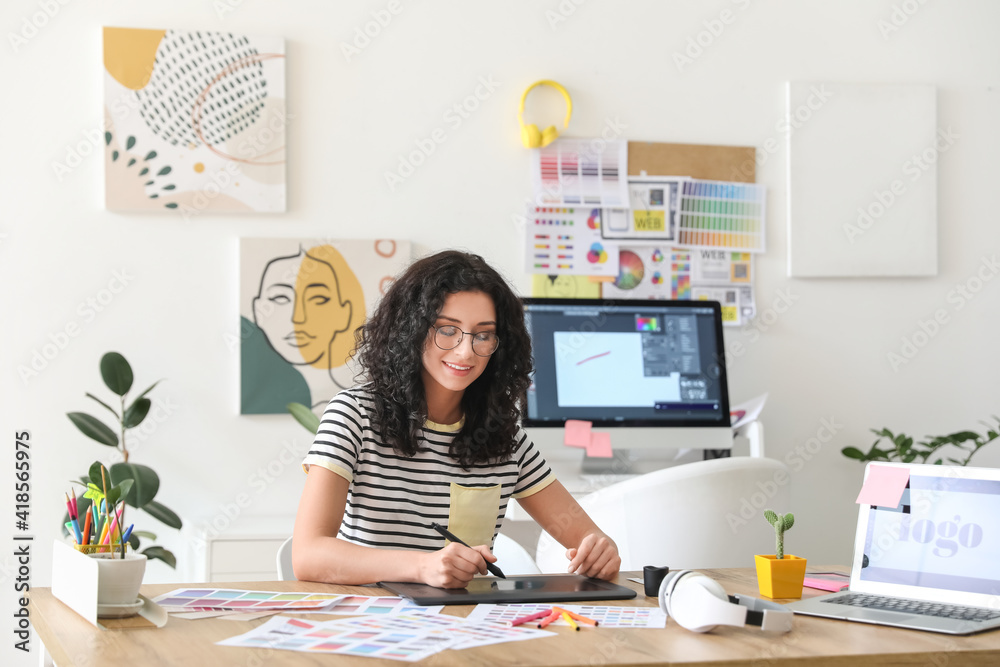 Young female designer working in office - obrazy, fototapety, plakaty 