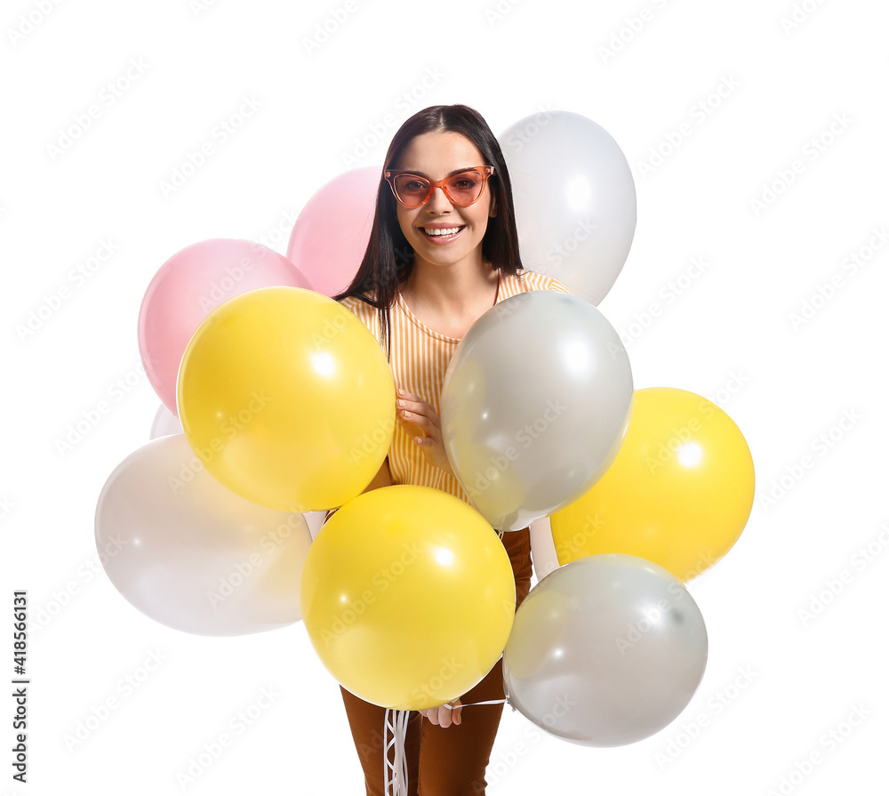 Beautiful young woman with balloons on white background