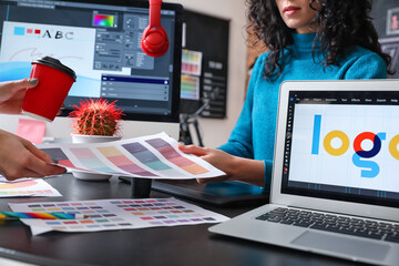 Poster - Female designer with colleague working in office