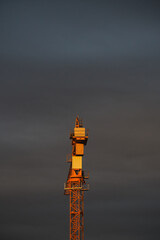 crane at sunset with clouds in the sky