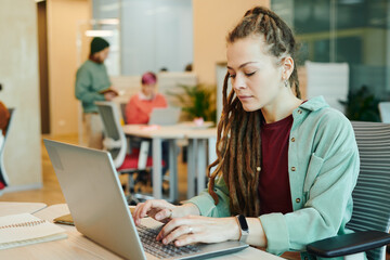 Wall Mural - Serious young contemporary female office manager preparing presentation