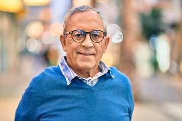 Wall Mural - senior grey-haired man smiling happy standing at the city.