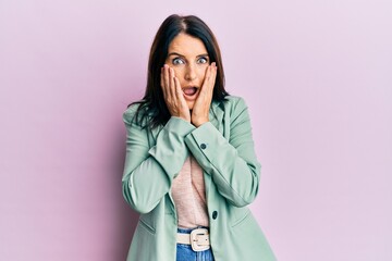 Poster - Middle age brunette woman wearing casual clothes afraid and shocked, surprise and amazed expression with hands on face