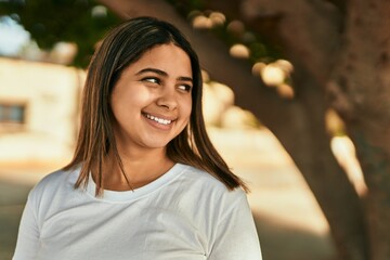 Sticker - Young latin girl smiling happy standing at the park.