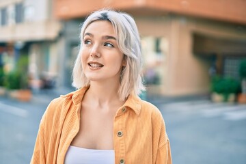 Sticker - Young blonde girl smiling happy standing at the city.