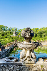 Wall Mural - A statue in the Isolotto, an oval-shaped island with the Fountain of the Ocean in the middle, in Boboli Gardens, beside Palazzo Pitti, Florence city center, Tuscany region, Italy