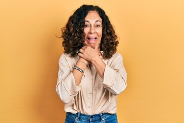 Poster - Middle age hispanic woman wearing casual clothes shouting and suffocate because painful strangle. health problem. asphyxiate and suicide concept.