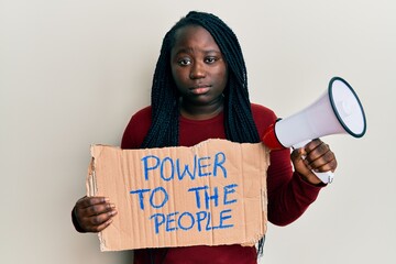 Sticker - Young black woman with braids holding power to the people banner and megaphone skeptic and nervous, frowning upset because of problem. negative person.