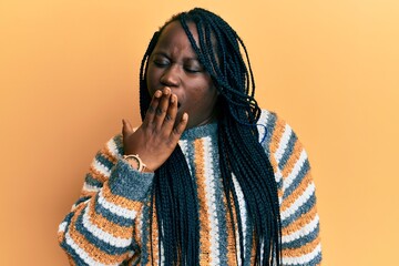 Poster - Young black woman with braids wearing casual winter sweater bored yawning tired covering mouth with hand. restless and sleepiness.