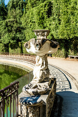 Wall Mural - A statue in the Isolotto, an oval-shaped island with the Fountain of the Ocean in the middle, in Boboli Gardens, beside Palazzo Pitti, Florence city center, Tuscany region, Italy