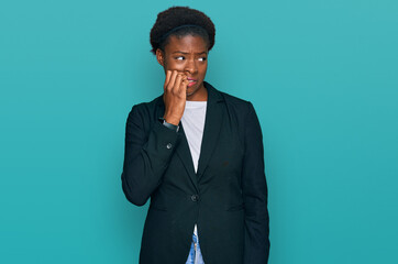 Poster - Young african american girl wearing business clothes looking stressed and nervous with hands on mouth biting nails. anxiety problem.