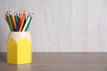 Many Different Pencils In Holder On Wooden Table, Space For Text