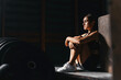 © Margo Basarab - Fit young woman at a crossfit style on dark gray background. Fitness, functional, training, and lifestyle concept