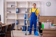 © Elnur - Young male contractor cleaning the office