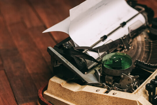 vintage typewriter for printing white sheet of paper wooden background retro invention