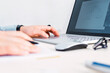 © Marcela Ruty Romero - Close up of male hands using laptop in office, man's hands typing on laptop keyboard indoors, side view of businessman using laptop.