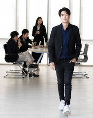 Wall Mural - An executive look tomboy woman in casual suit walking in office with smart and confident gesture