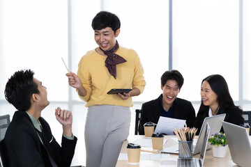 Wall Mural - A group of multi sex colleagues, tomboy, transgender and lesbian businesspeople working together with happy and intimate manner. Teamwork and unity of workplace concept