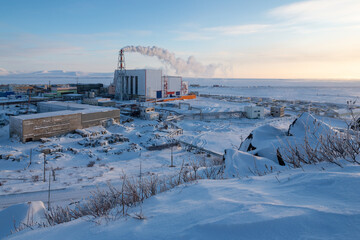 Wall Mural - arctic industrial landscape. view of a large thermal power plant in the tundra. thick plumes of smok